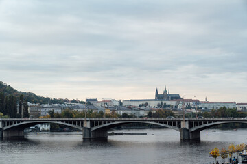 Fototapeta na wymiar Riverside scenery in Prague, Czech Republic with Prague Castle, bridges and buildings