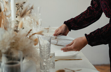 Close Up Photo Of Woman Hands Setting Up Christmas Dinner Table At Home