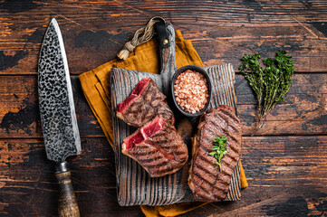 Oyster Top Blade beef meat steak grilled on summer BBQ. Wooden background. Top View