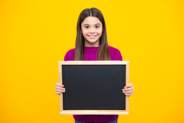 Fototapeta premium School sales board. Cheerful teenage girl kid hold blackboard chalkboard with copy space.