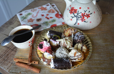 Christmas cookies on a plate and coffe cup on a decorated table. Dessert of cookies plate perfect for celebrating Christmas.