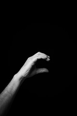 Hand demonstrating the French sign language letter 'C' with copy space