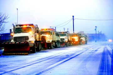 Snow Plows in Severe Blizzard Preparing for Storm