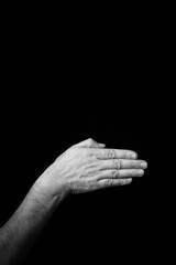 Hand demonstrating the French sign language letter 'M' with copy space