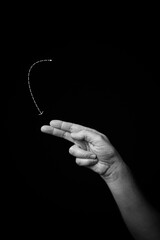 Hand demonstrating the French sign language letter 'P' with copy space
