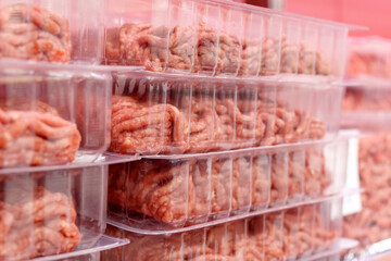 Raw minced meat in plastic packages in hypermarkets. Pink and white meat ingredients texture