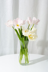 Light spring flowers in vase on table