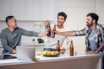 Men drinking an alcoholic drink in the kitchen
