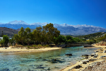 Fototapeta na wymiar River mouth and view of the Lefka Ori mountains in the town of Georgioupoli on the island of Crete