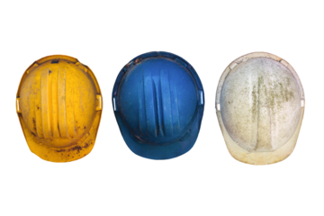 Three old and worn construction helmets