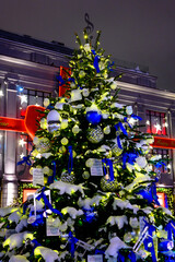 The streets of city decorated with christmas trees and garlands during New Year's Eve. The snowstorm.