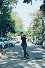 Young man traveller hand holding ice coffee walking on a street