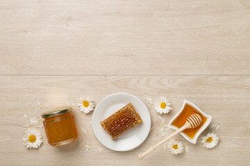 Composition with fresh honey on wooden background, top view