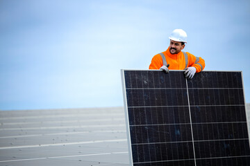 Experienced worker installing solar panels for sustainable energy production.