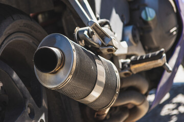 Close up to a sport motorcycle exhaust pipe on a sunny day