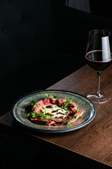 sliced steak on a plate with sauce and herbs