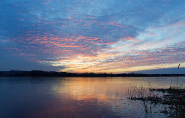 Fototapeta na wymiar Sunset over the lake. Winter landscape.