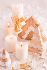 Fototapeta na wymiar Christmas decoration with candles and wooden Christmas trees