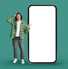 Shocking Offer. Surprised Hipster Guy Pointing At Big Blank Smartphone