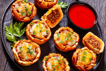 sloppy joe cups on black plate, top view