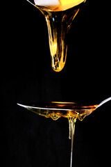 honey drizzling onto a spoon 