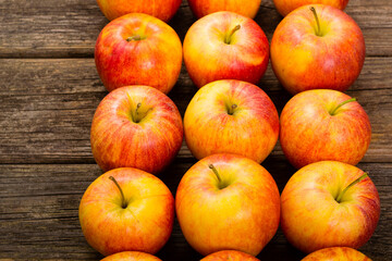 apple fruits in a row, old weathered wood table background