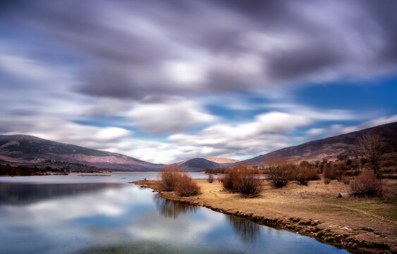 Fast clouds over Pinilla del Valle reservoir, in Madrid province.
