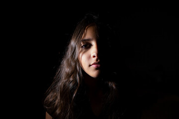 Portrait of a teen girl in low key light