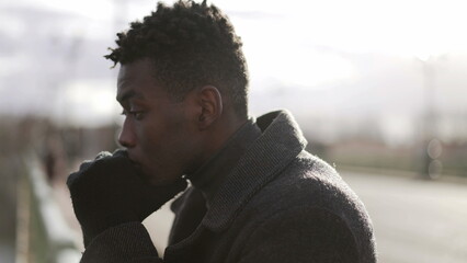 Pensive black African man standing by bridge thinking about life looking at horizon2 - Powered by Adobe