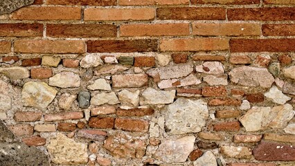 rustic stone wall and red bricks background