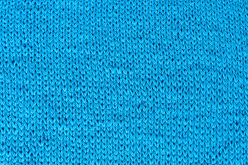 Knitted fabrics. Background from blue jersey. Knitted fabric.