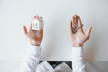 Real estate agent with house model and keys