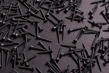 Metal, Stainless Steel Self Tapping Screws on black wooden background