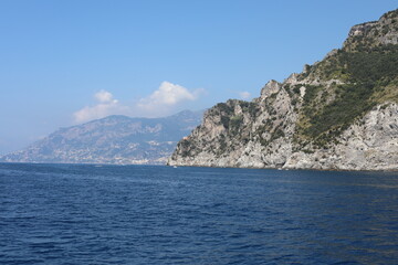 Fototapeta premium view of the sea and mountains. view of the coast of island. coast of the region. landscape with mountains and sea. landscape with blue sky and clouds. sea and rocks