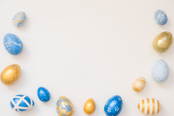 Frame of Easter decorated eggs isolated on white background. Minimal easter concept. Happy Easter card with copy space for text. Top view, flatlay.