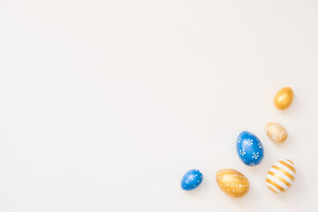 Blue Easter decorated eggs isolated on white background. Minimal easter concept. Happy Easter card with copy space for text. Top view, flatlay.