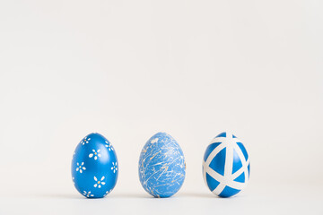 Three Easter golden decorated eggs on white background. Minimal easter concept. Happy Easter card...