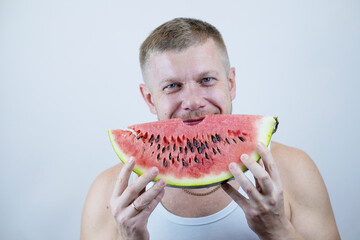 man eat watermelon. man holding a ripe watermelon