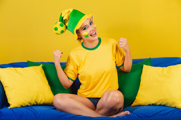 Caucasian Woman, Redhead, Brazil Soccer Supporter, Brazilian, On Couch Celebrating