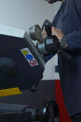 close-up of a man working and cutting metal with industrial saw