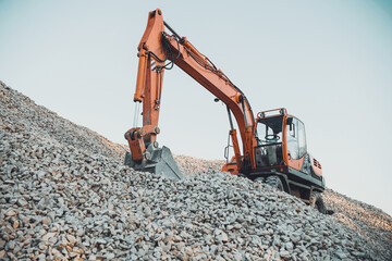 tractor with a bucket on a pile of rubble. special equipment for earthworks. excavator digs rubble
