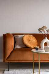Elegant, ocher colored sofa and decorations, close-up