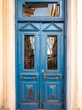 Old vintage blue wooden door with glass.