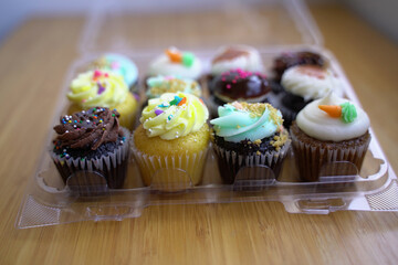Assortment of 12 cupcakes in a container