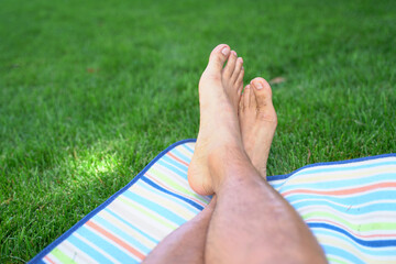 Close up of feet resting at a park
