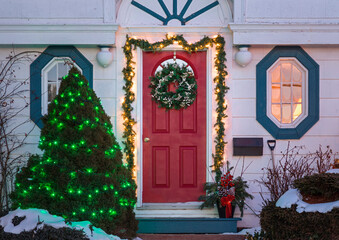 A traditional older home decorated for Christmas.