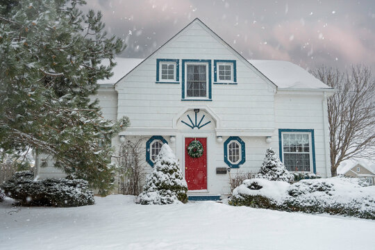 A traditional older North American home buried in snow.