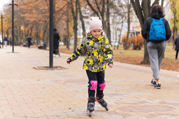 Cute little girl learning to roller skate