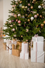 Craft gifts under the tree. The concept of Christmas and New Year.Christmas mood. Celebrating of New Year.Many boxes of Christmas gifts in eco-friendly craft paper packaging
