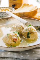 Speck dumplings cooked in vegetable broth. Typical Tyrolean dish.